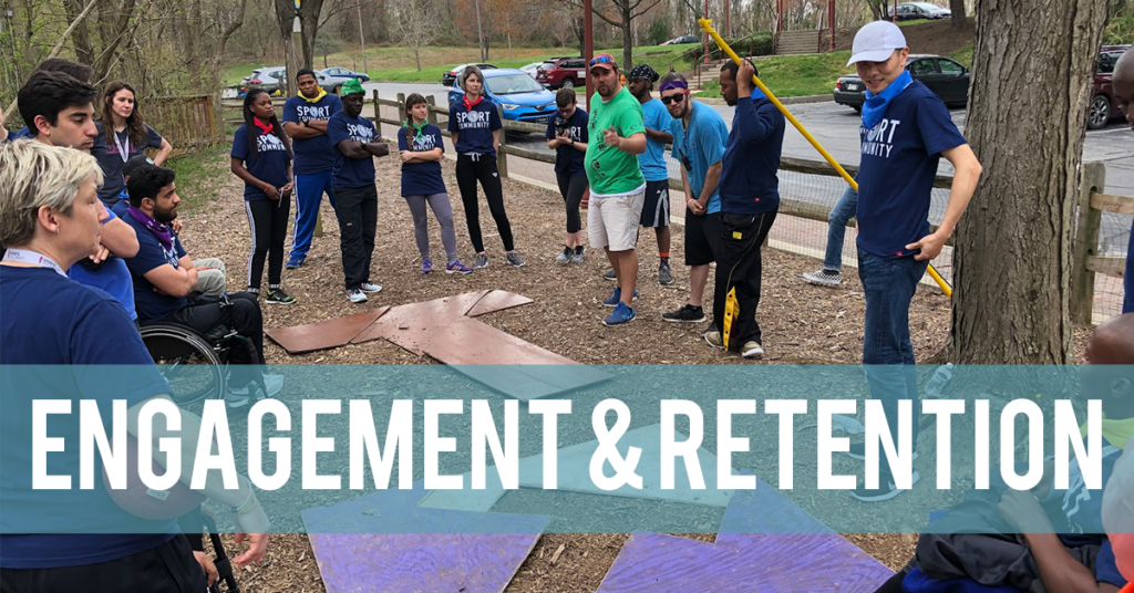 A group forms a "T" shape during a team building exercise.