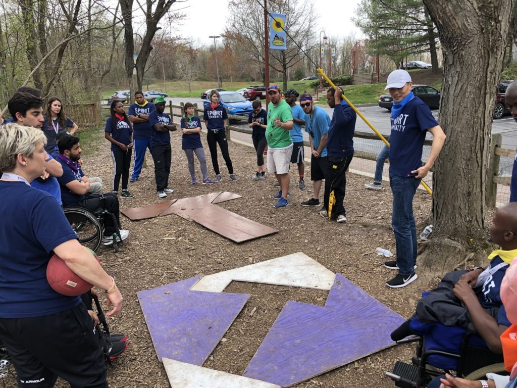 A group forms a "T" shape during a team building exercise.